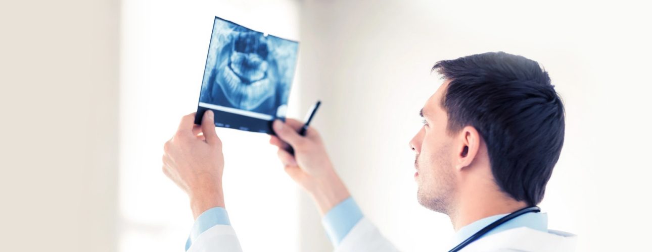 A dentist checking digital x-ray